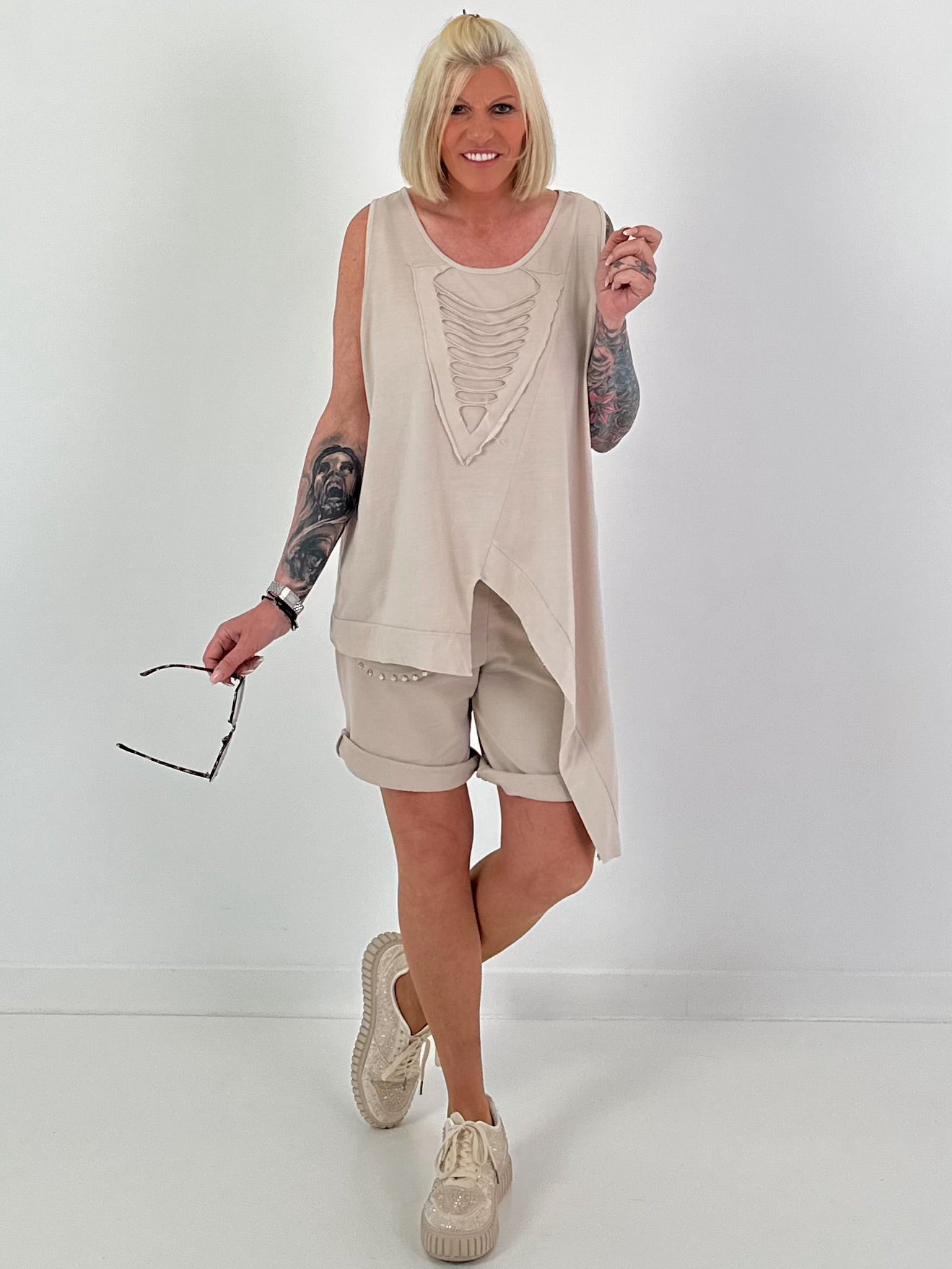 Top with cut-out and asymmetrical hem - beige