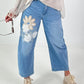 Bottle jeans with floral appliqués - denim