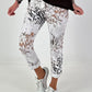 All-over patterned trousers - white-multicoloured