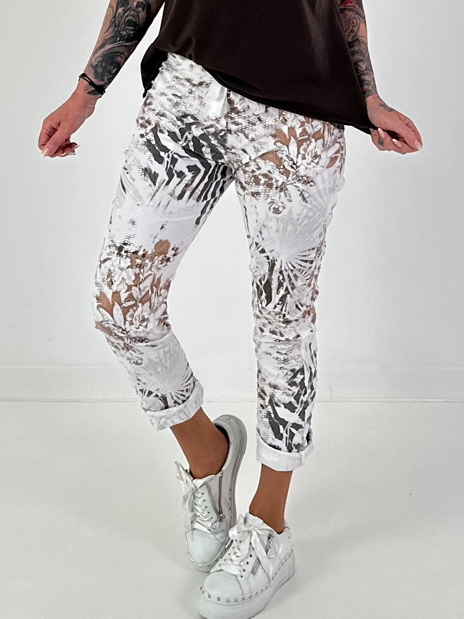 All-over patterned trousers - white-multicoloured