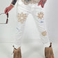 Jeans with crocheted floral appliqués - white