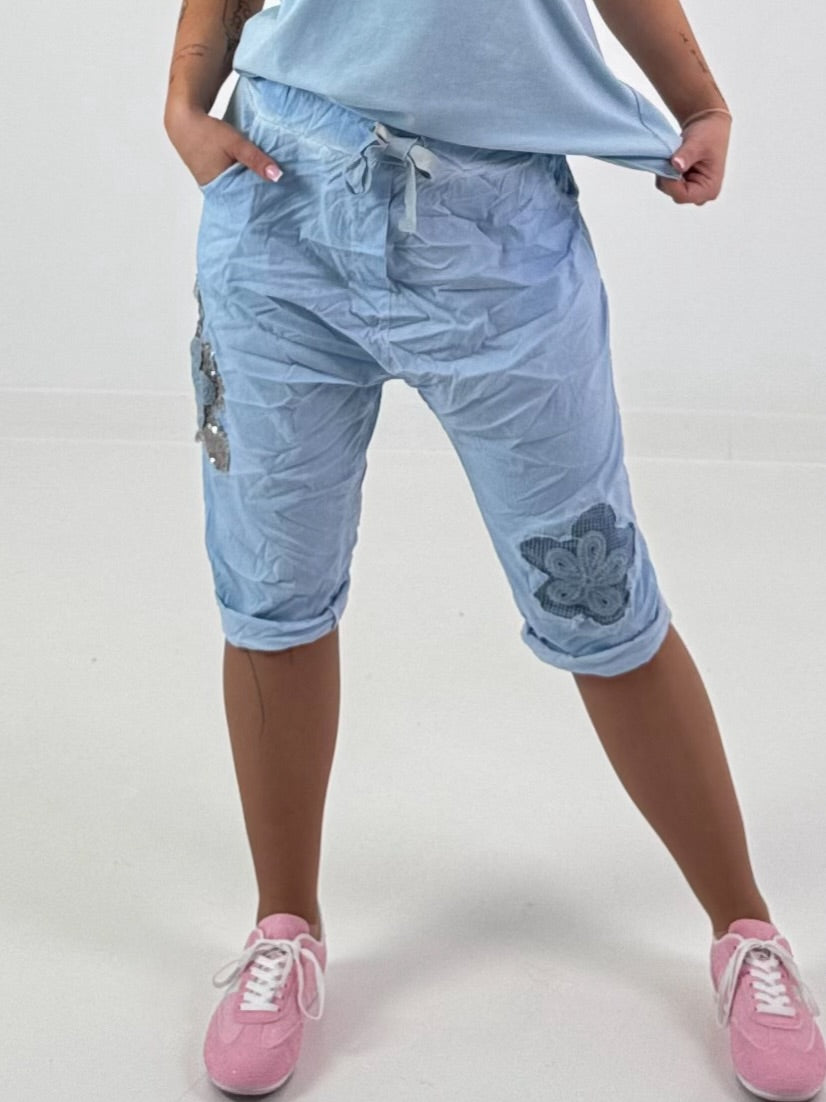 Short Baggy Shorts with Crocheted Flowers and Sequins - Light Blue