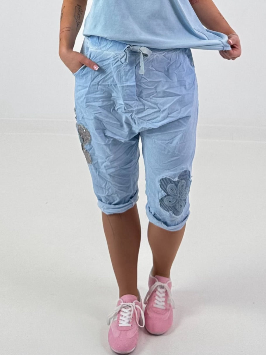 Short Baggy Shorts with Crocheted Flowers and Sequins - Light Blue