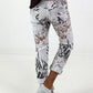 All-over patterned trousers - white-multicoloured