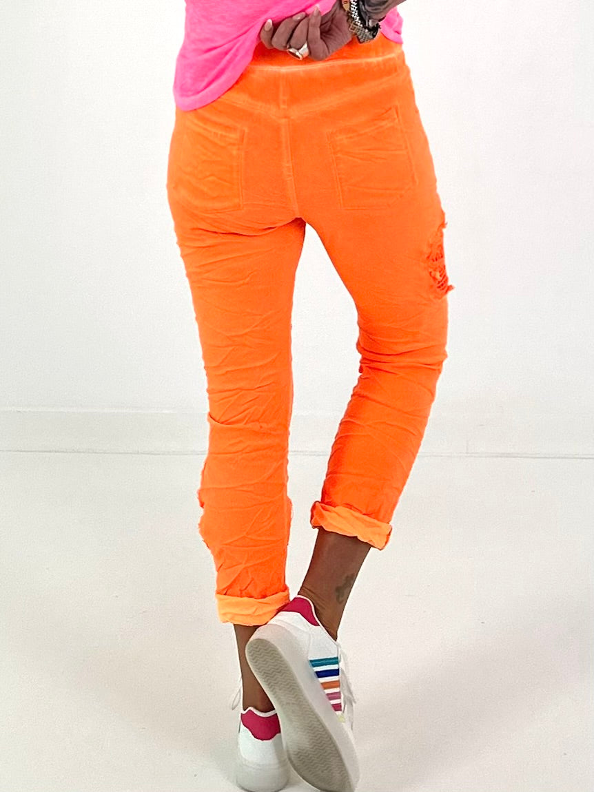 Trousers with crochet flowers - neon orange