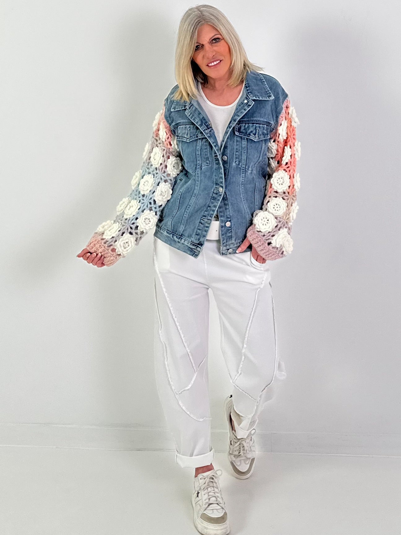 Denim jacket with crocheted sleeves