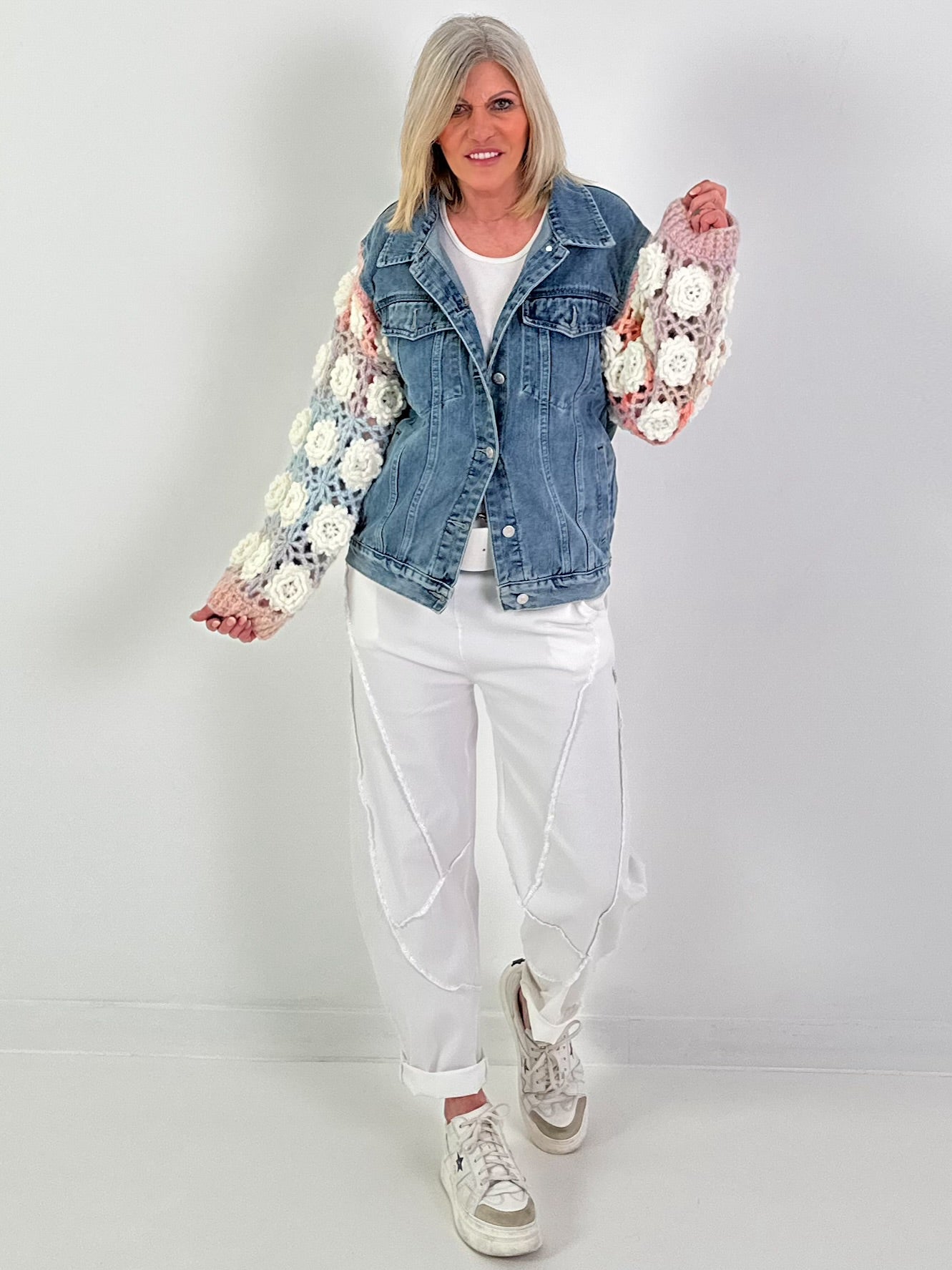 Denim jacket with crocheted sleeves