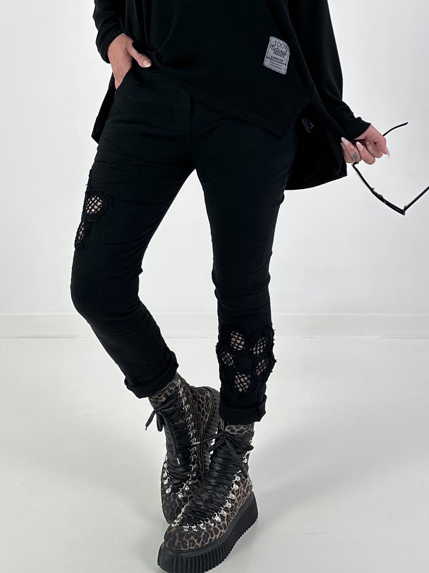 Trousers with crocheted flower inserts - black