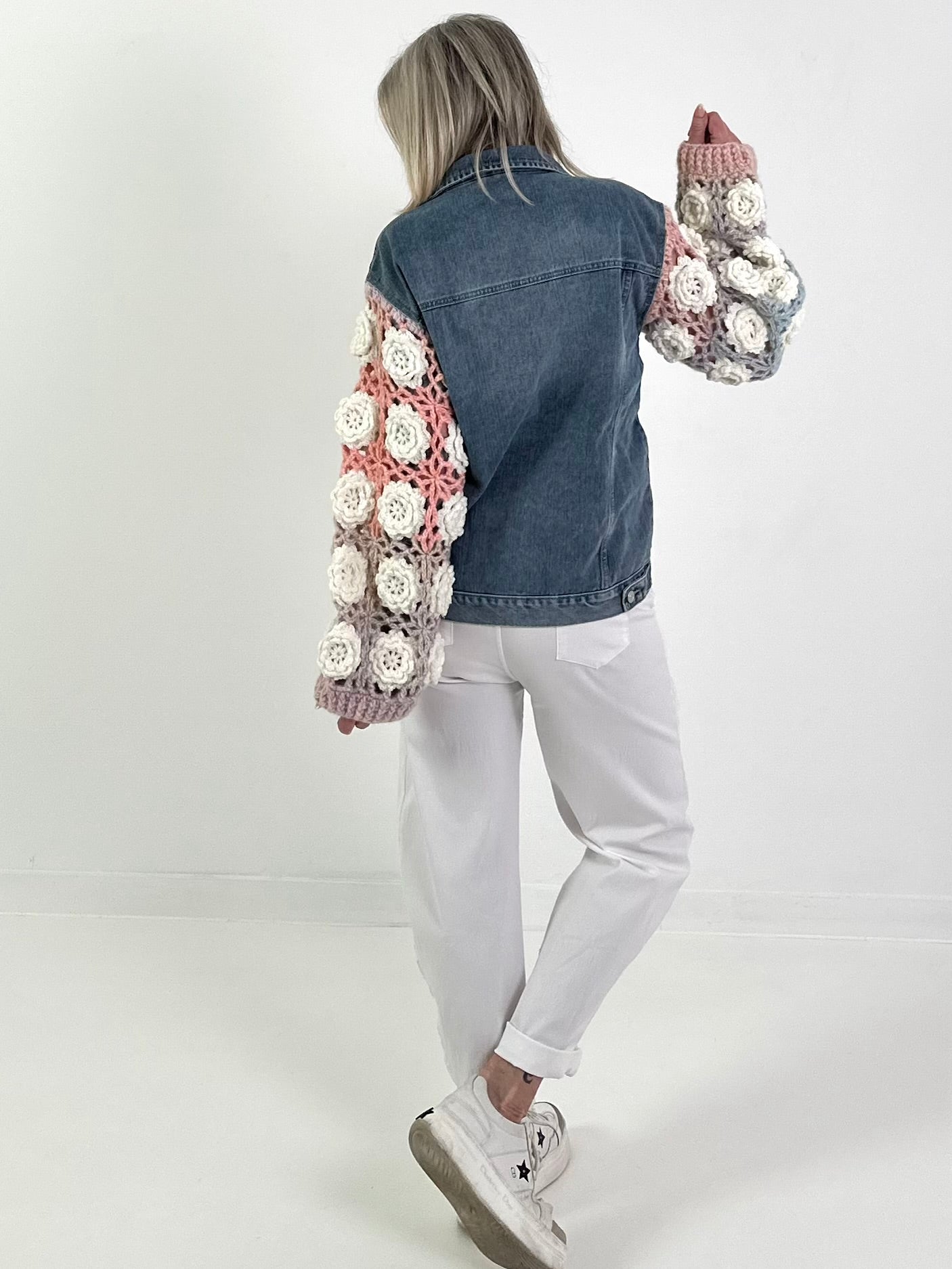Denim jacket with crocheted sleeves