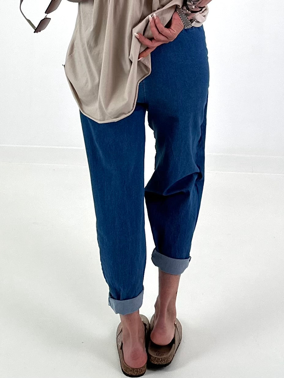 Dark blue jeans with silver eyelets