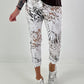 All-over patterned trousers - white-multicoloured