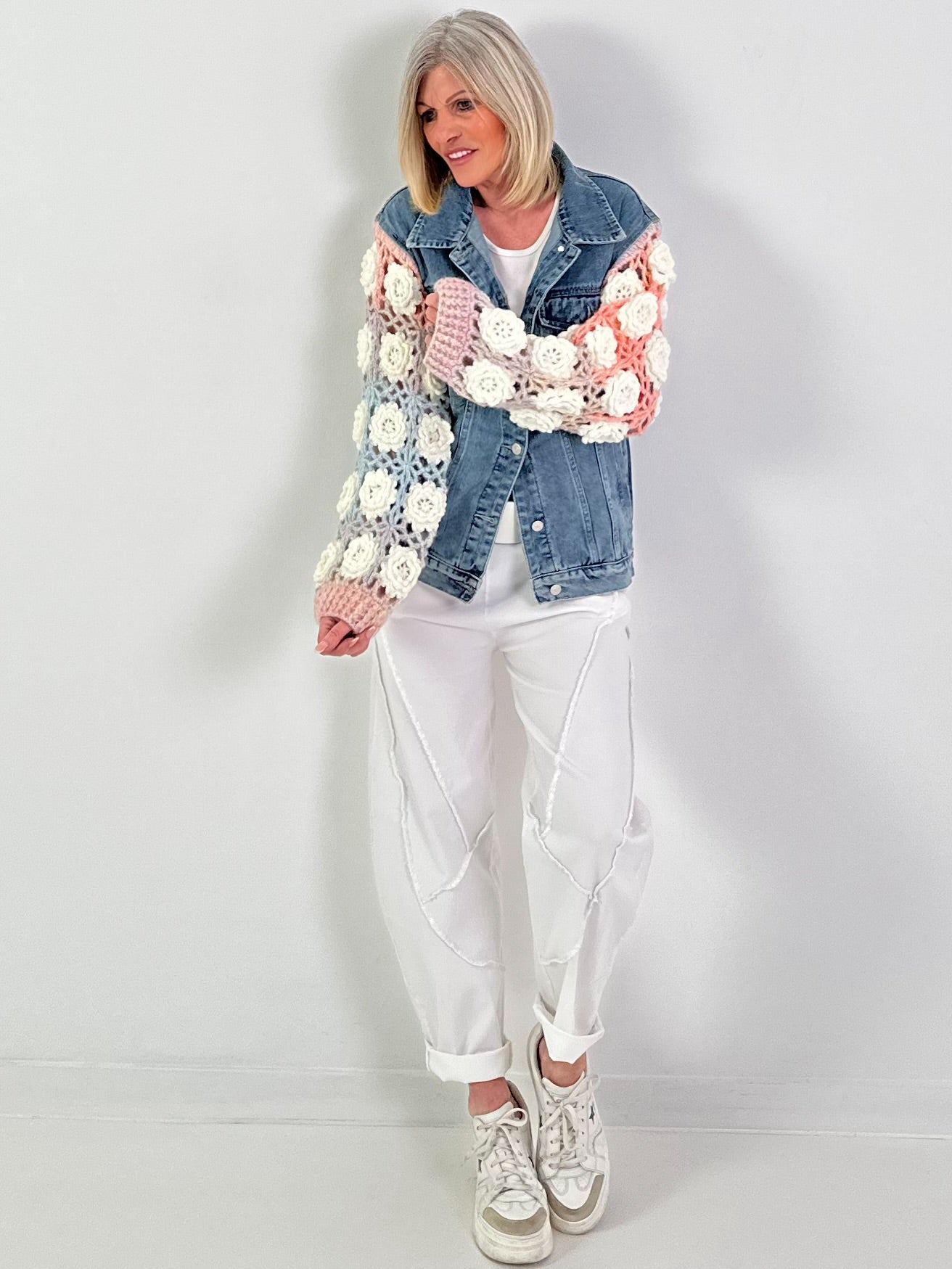 Denim jacket with crocheted sleeves