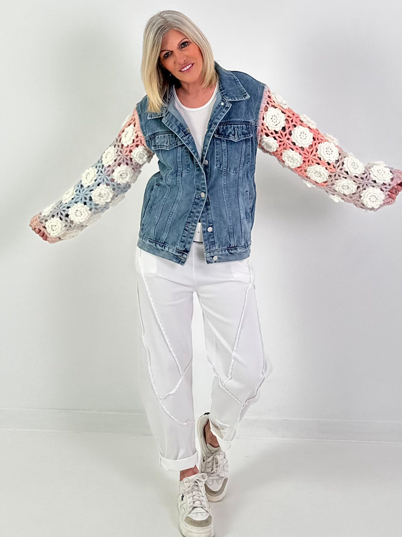 Denim jacket with crocheted sleeves