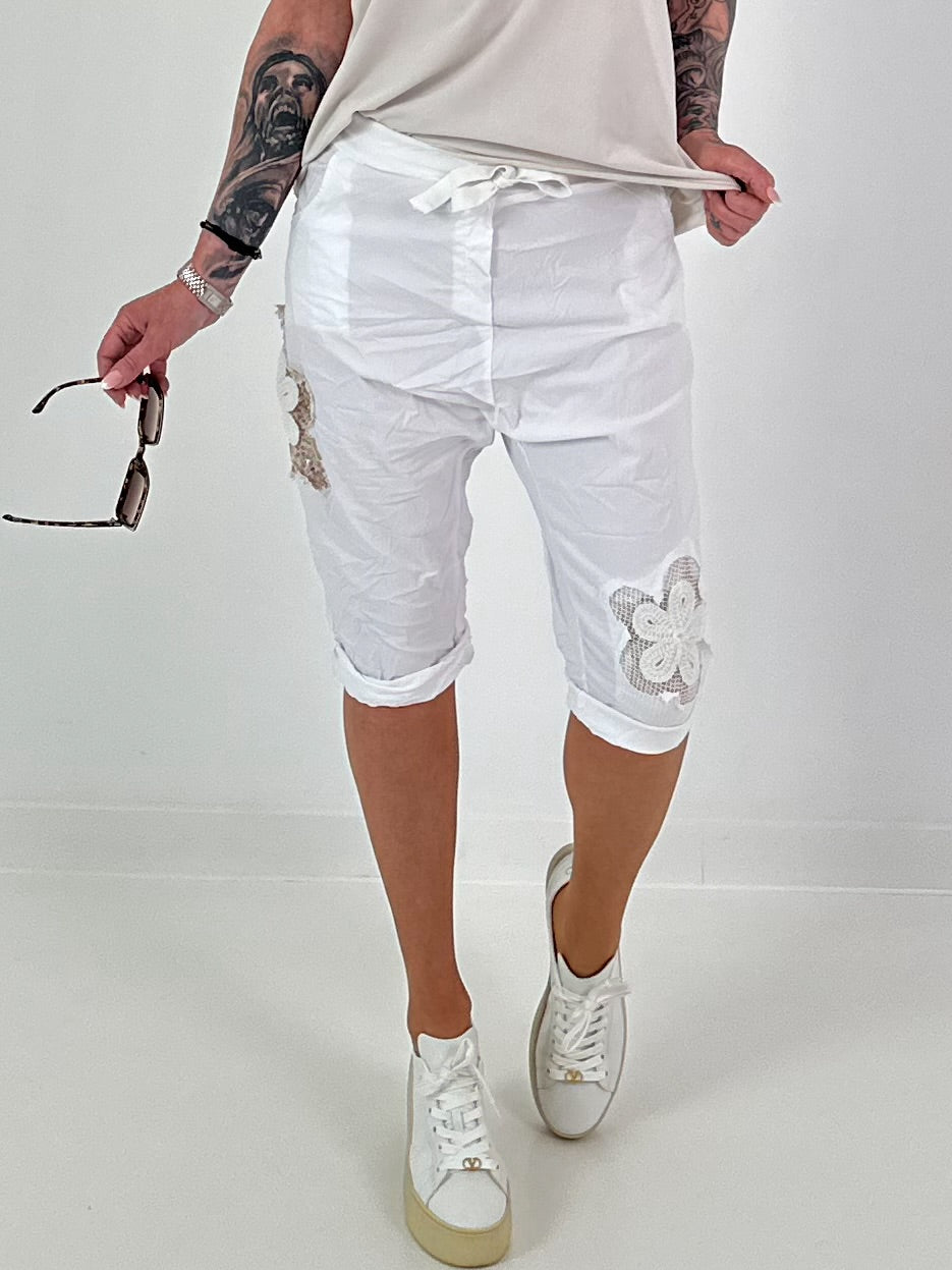 Short baggy shorts with crochet flowers and sequins - white
