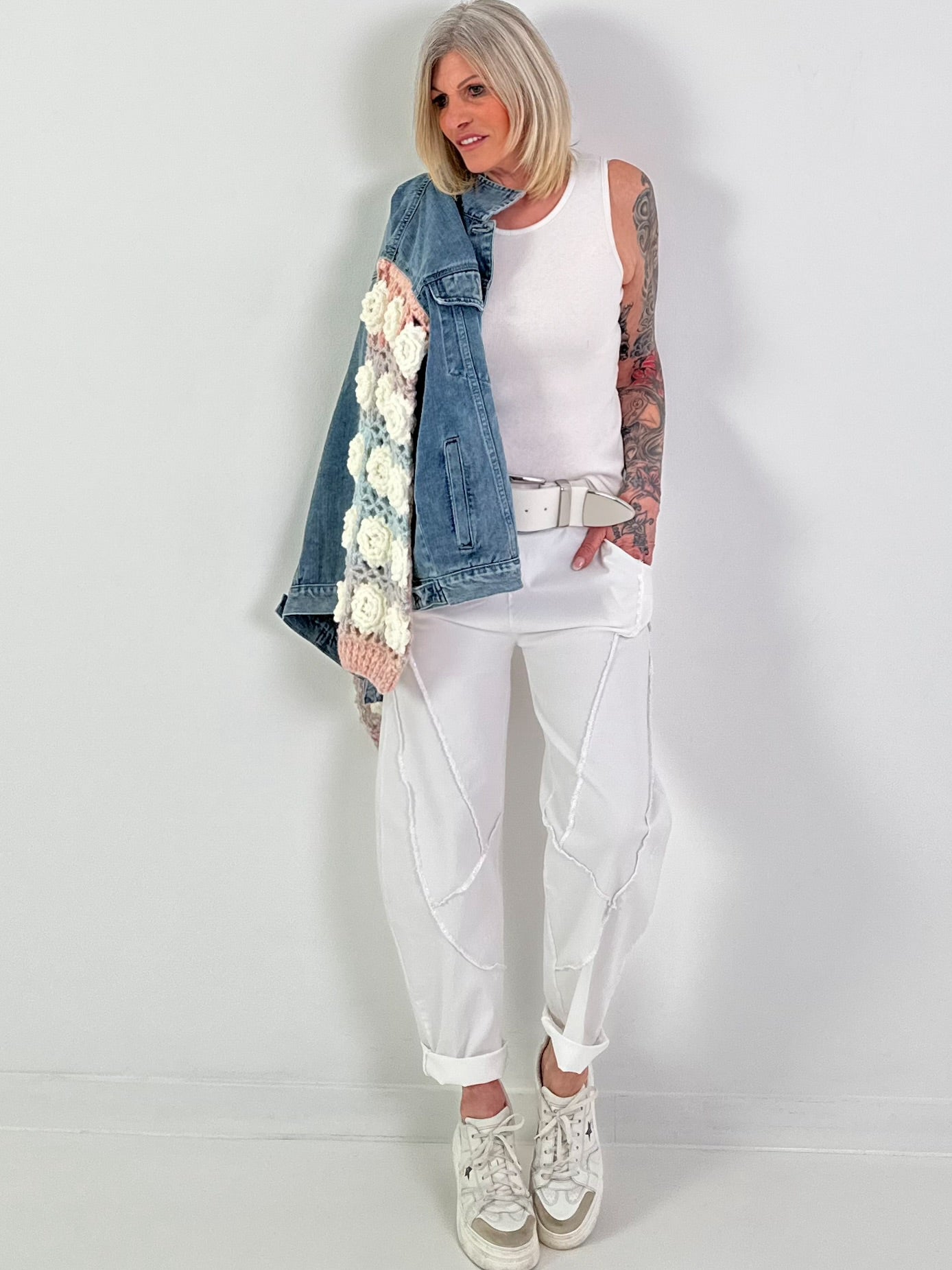 Denim jacket with crocheted sleeves
