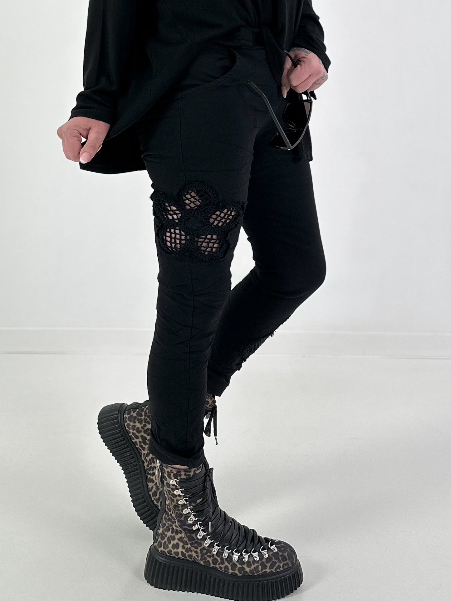 Trousers with crocheted flower inserts - black