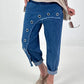 Dark blue jeans with silver eyelets