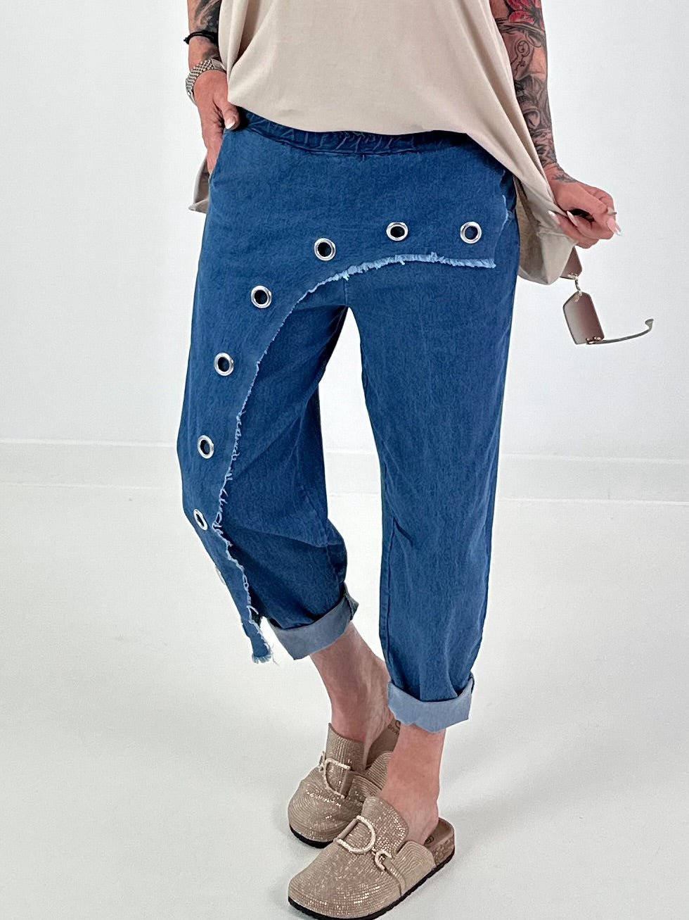 Dark blue jeans with silver eyelets