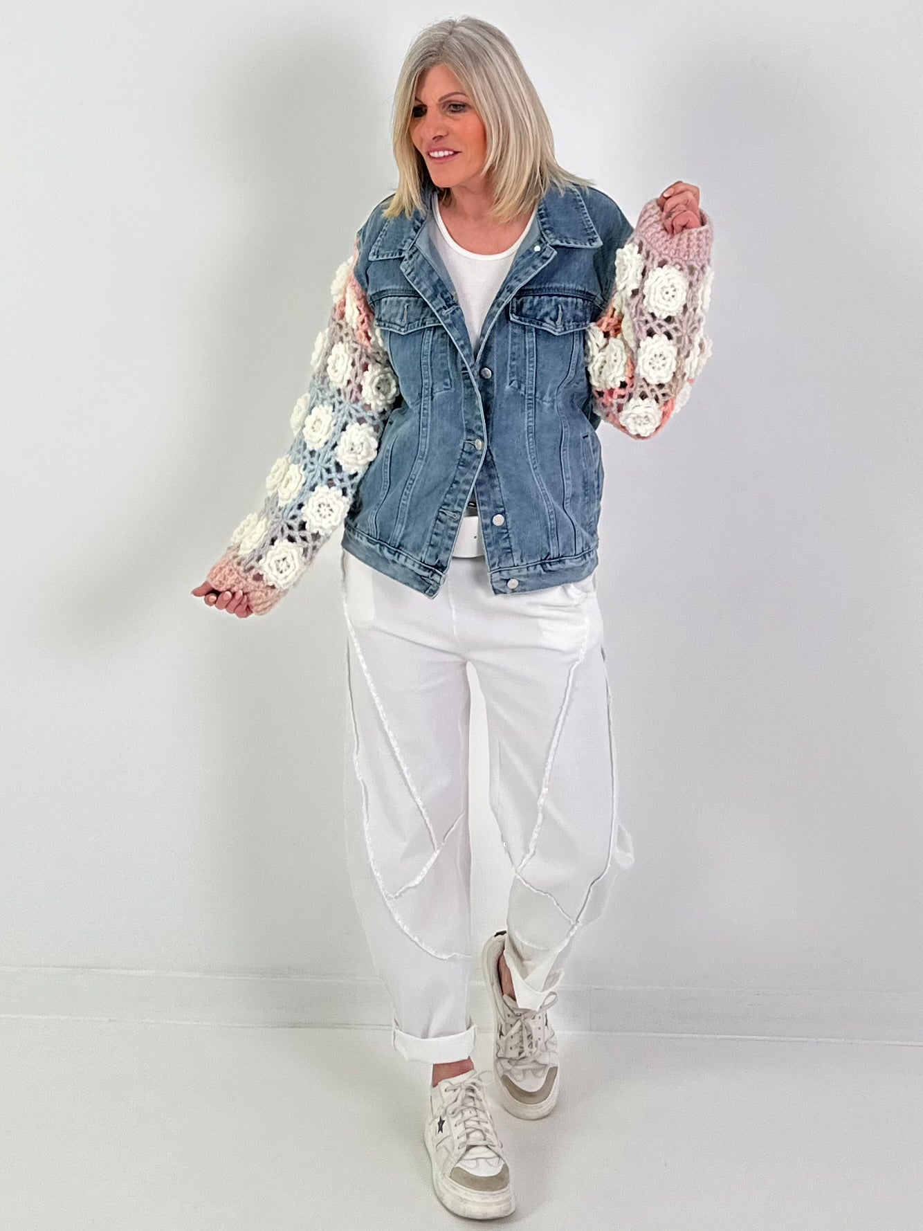 Denim jacket with crocheted sleeves