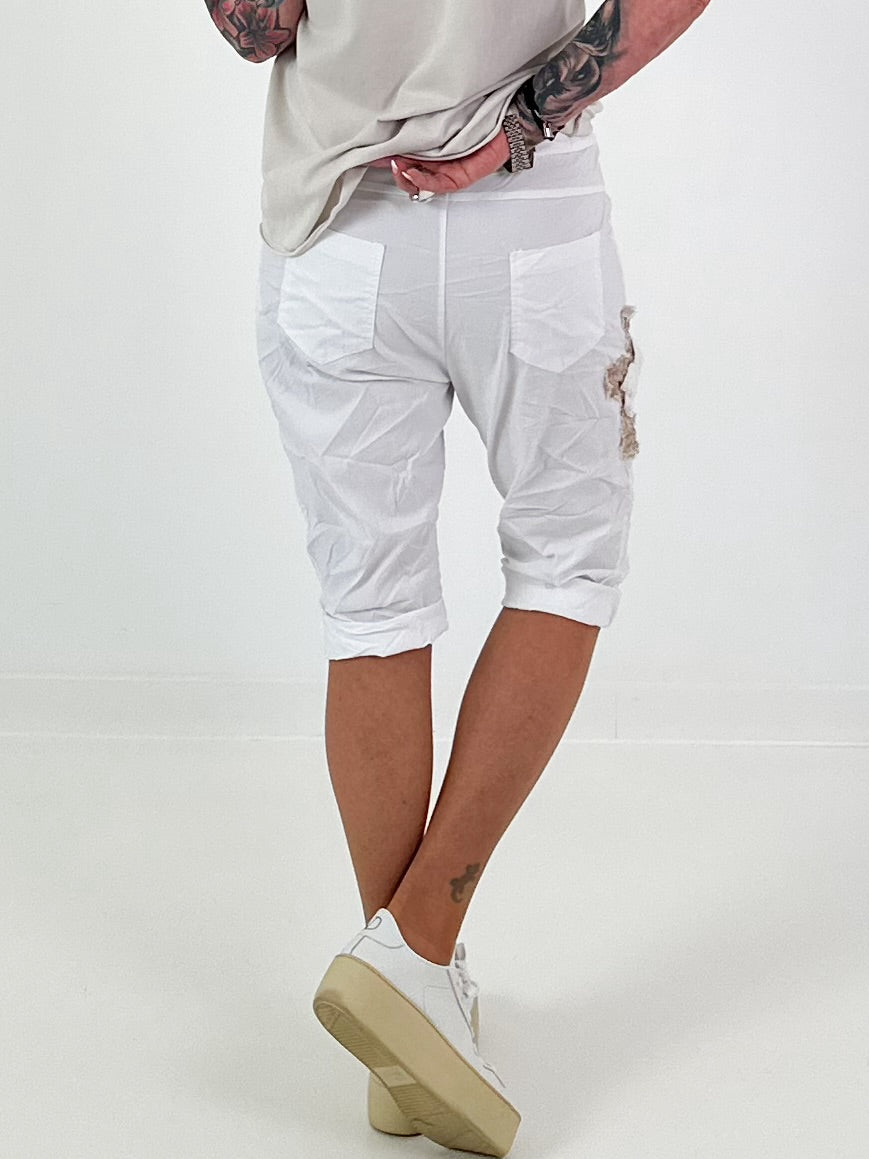 Short baggy shorts with crochet flowers and sequins - white