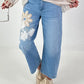 Bottle jeans with floral appliqués - denim