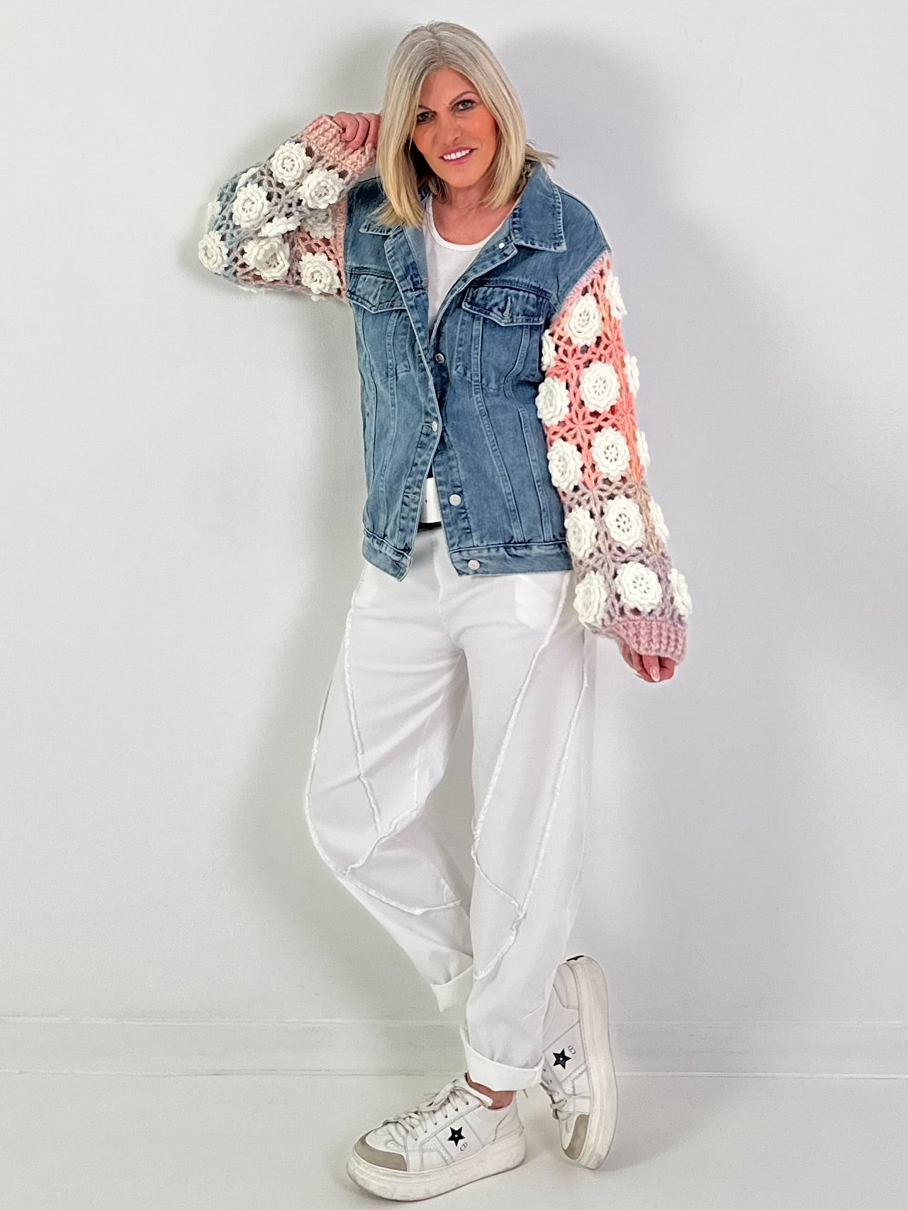 Denim jacket with crocheted sleeves