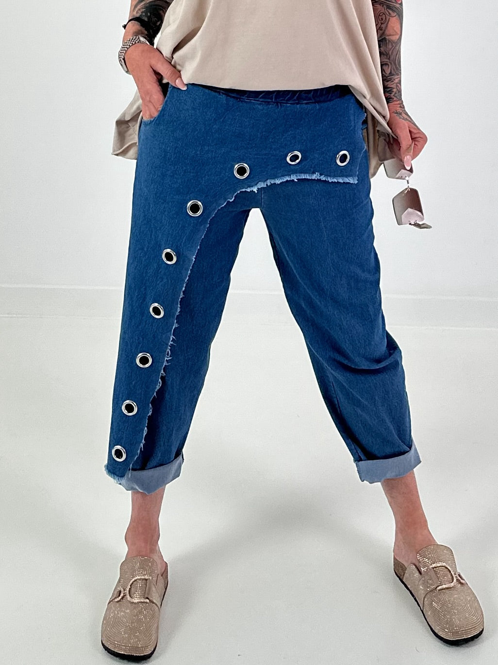 Dark blue jeans with silver eyelets