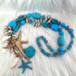 Shell necklace with starfish pendant - light blue